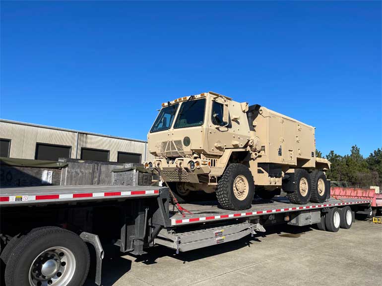 We specialize in moving military and heavy machinery on step-deck trailers